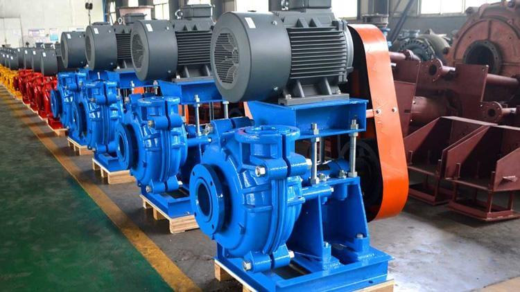 Line of blue heavy-duty slurry pumps with motors in a workshop