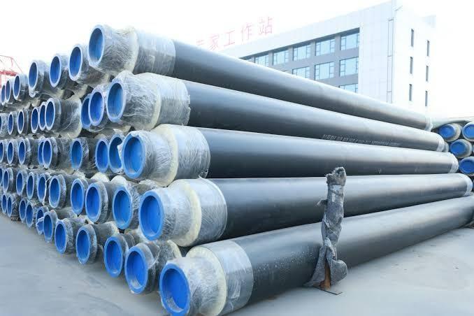 Stacked insulated and coated steel line pipe ready for pipeline construction
